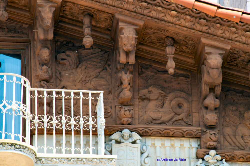 Detailed wood carvings surround a balcony Detailed wood carvings surround a balcony