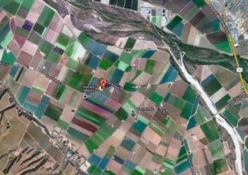 Mission Soledad in a mosaic of green fields