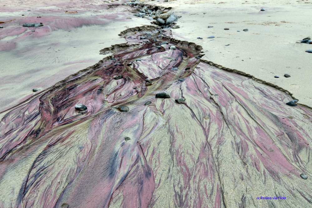 Garnet sand being washed onto the beach