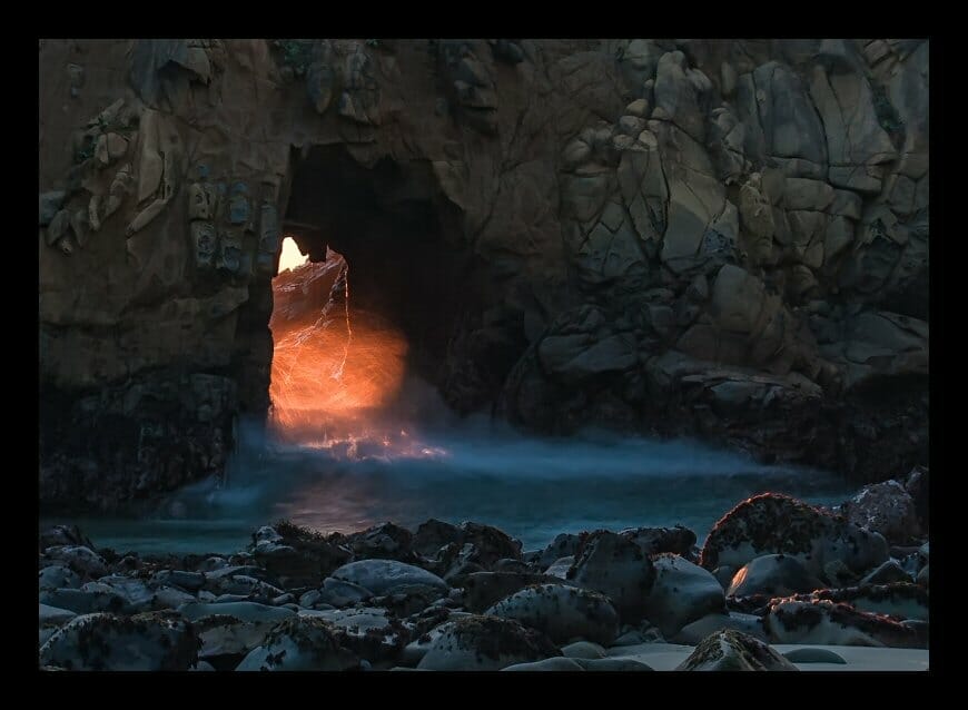 A cave with a light coming out of it.