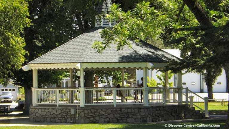 A gazebo sits in the middle of a park.