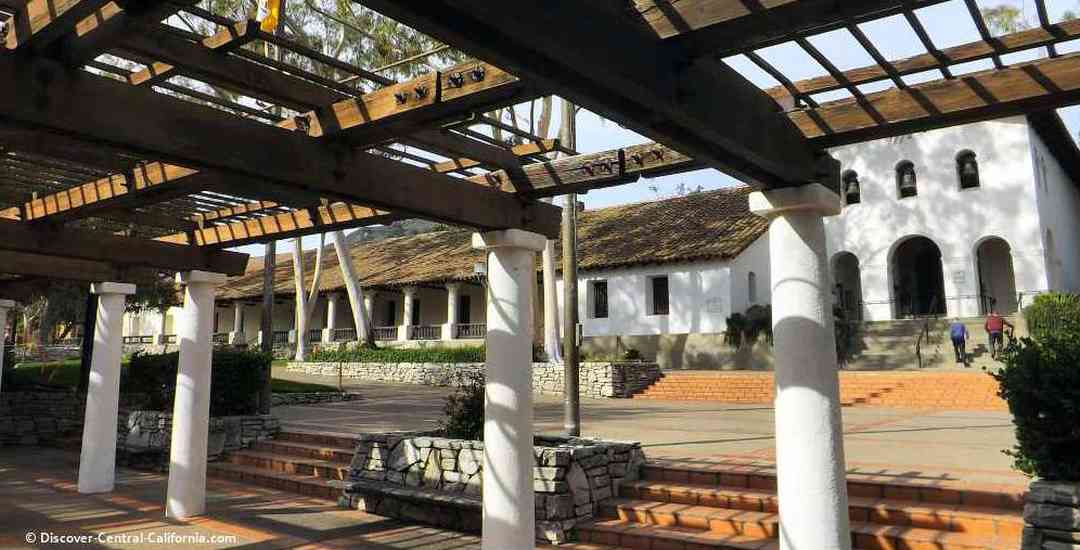 A wooden structure with white pillars.