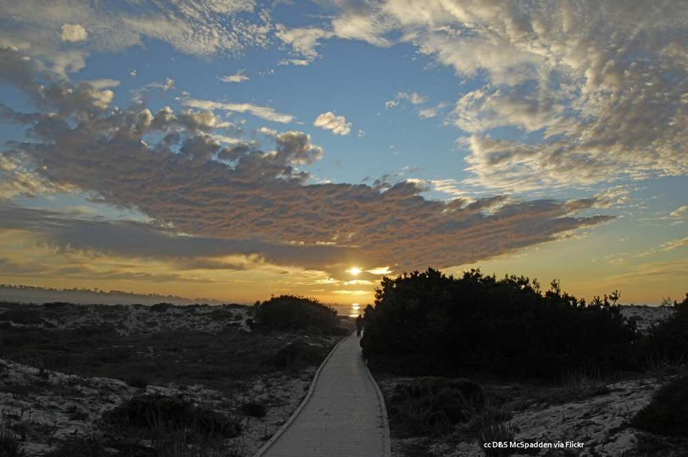 The setting sun over the Asilomar Beach boardwalk
