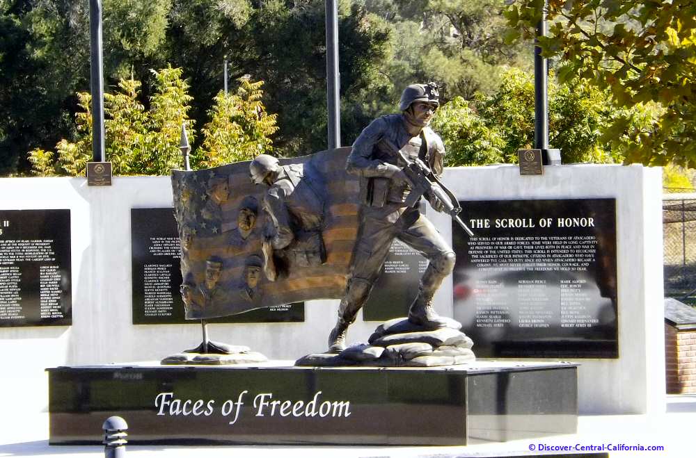 Faces of Freedom statue and the Heroes Wall behind