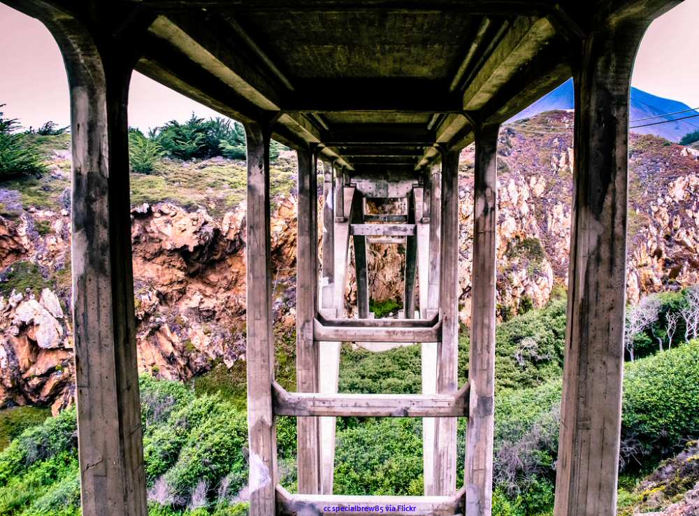 A view along the length of the bridge under the roadway